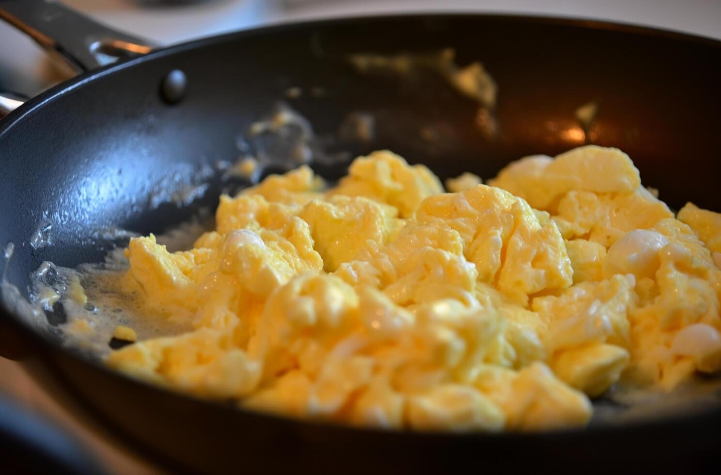 AI generated Scrambled eggs in skillet photo