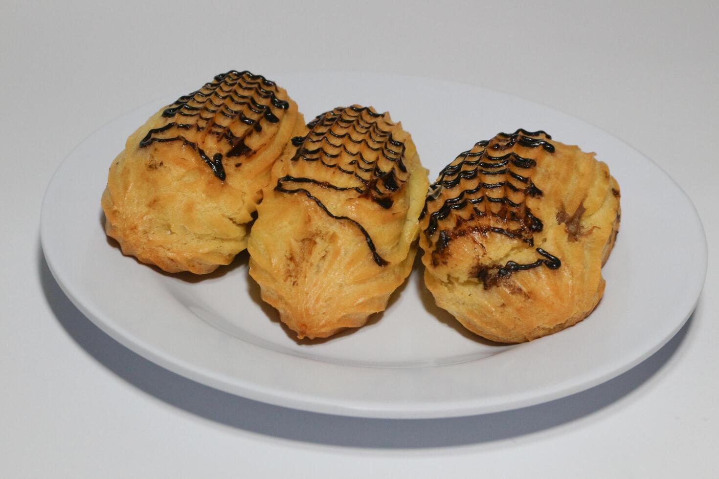 Chocolate eclairs with icing. Traditional French dessert. photo