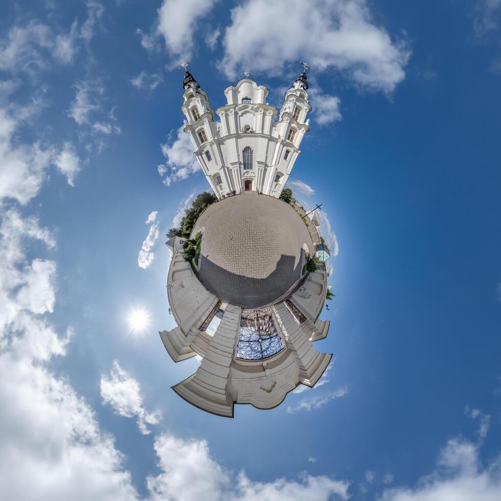 little planet transformation of spherical panorama 360 degrees overlooking church in center of globe in blue sky. Spherical abstract aerial view with curvature of space. photo