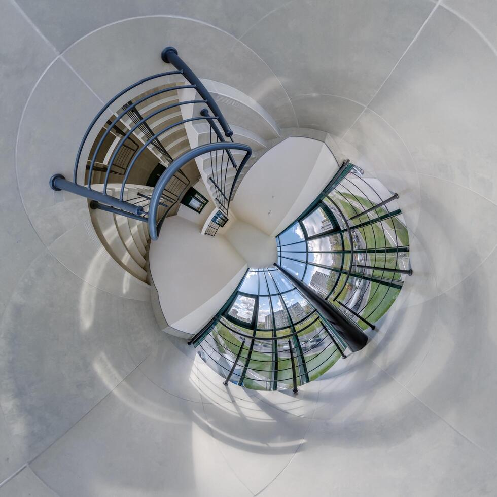 abstractly twisted into a spherical 360 panorama interior of a modern office with a hall staircase and panoramic windows photo