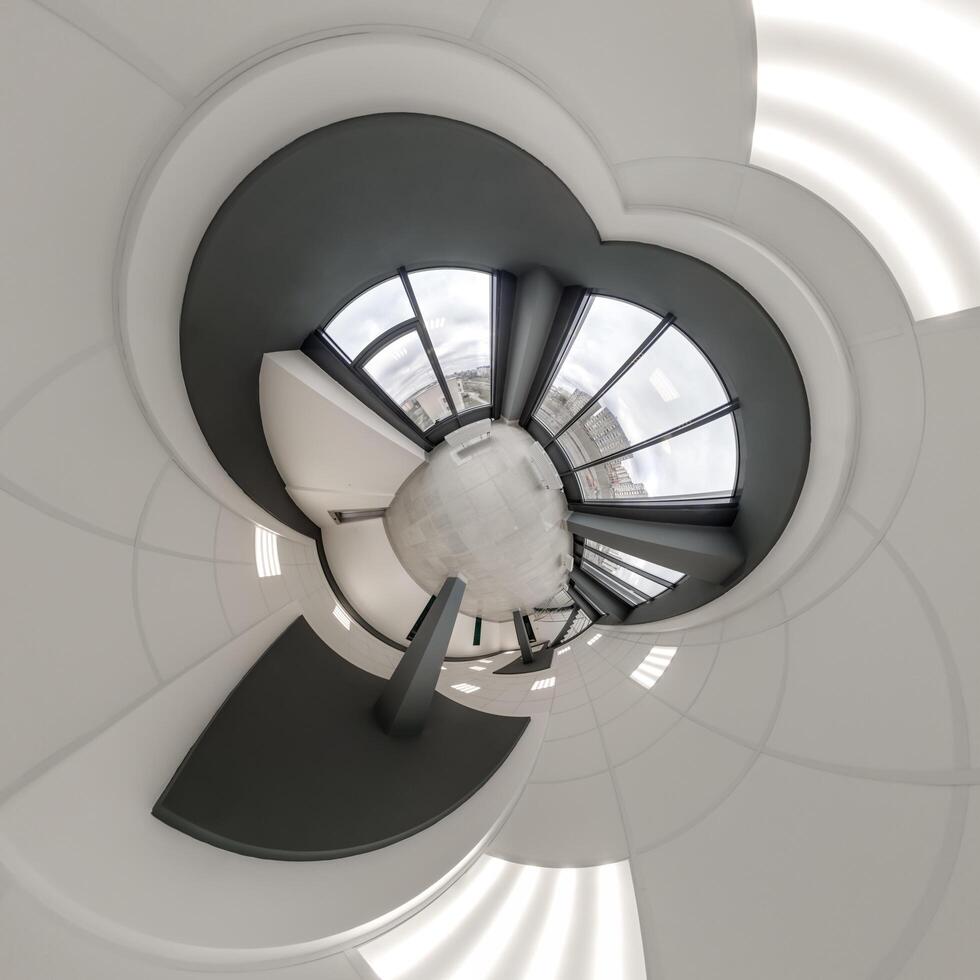 abstractly twisted into a spherical 360 panorama interior of a modern office with a hall staircase and panoramic windows photo