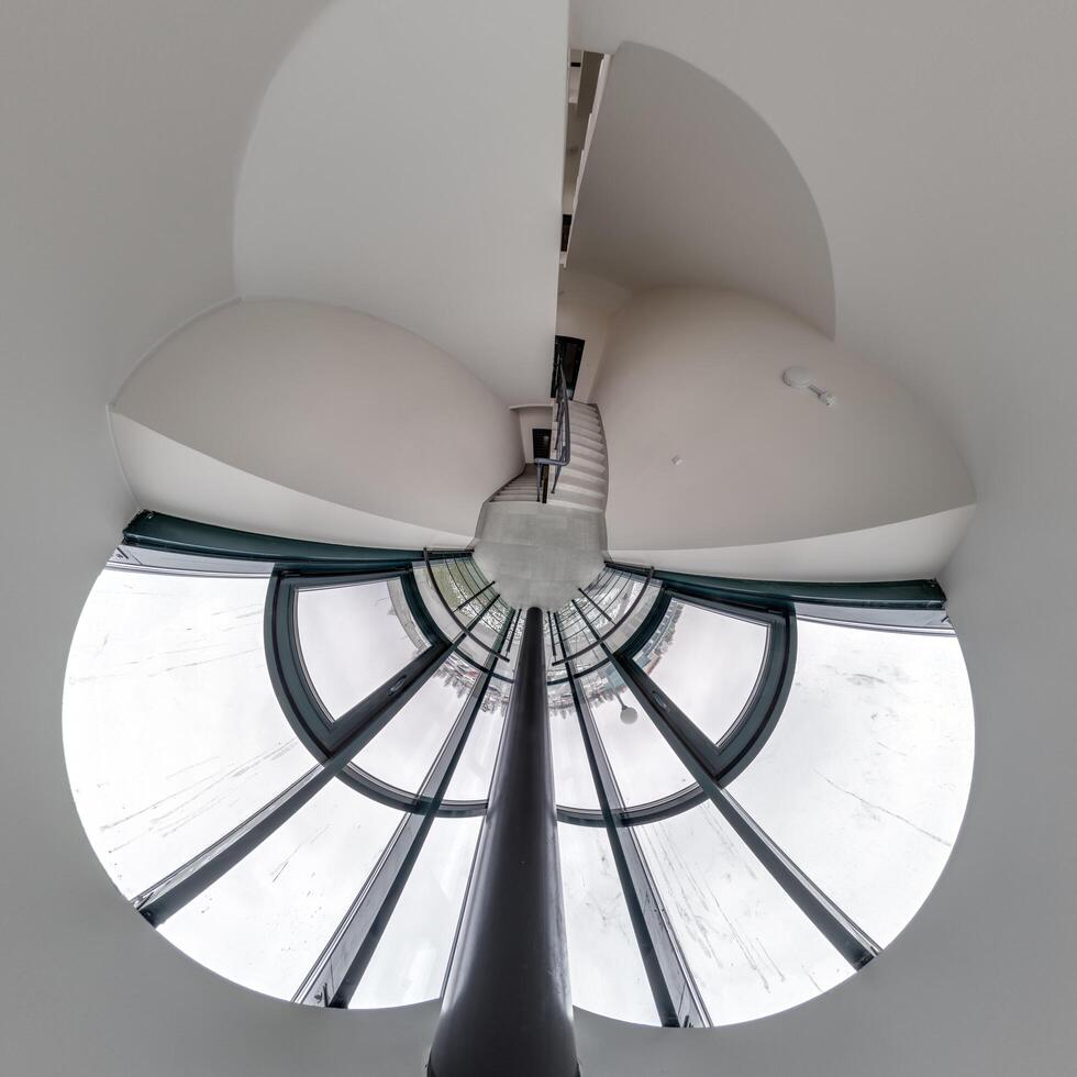 abstractly twisted into a spherical 360 panorama interior of a modern office with a hall staircase and panoramic windows photo