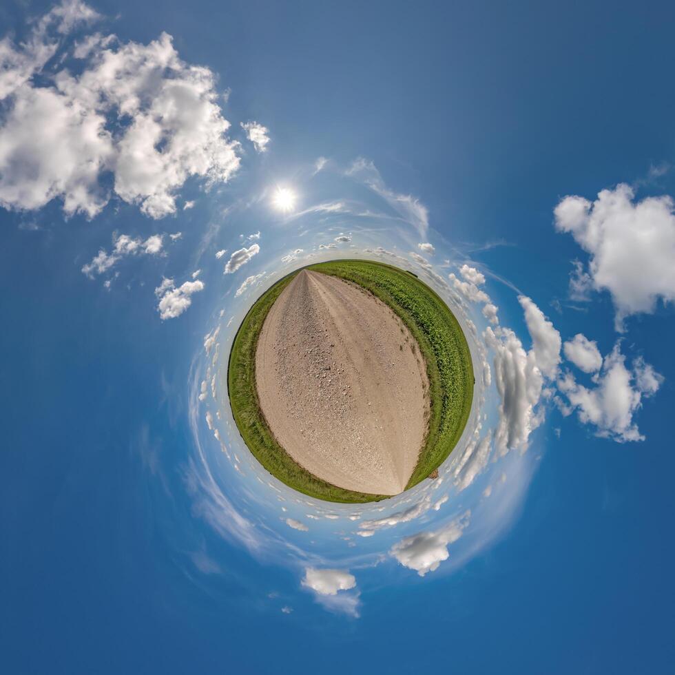 simple tiny planet without buildings in blue sky with beautiful clouds. Transformation of spherical panorama 360 degrees. Spherical abstract aerial view. Curvature of space. photo