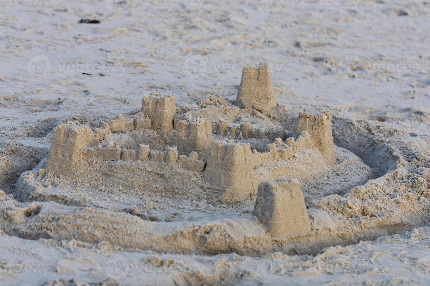 Sand Castle With Moat Trench On Beach photo