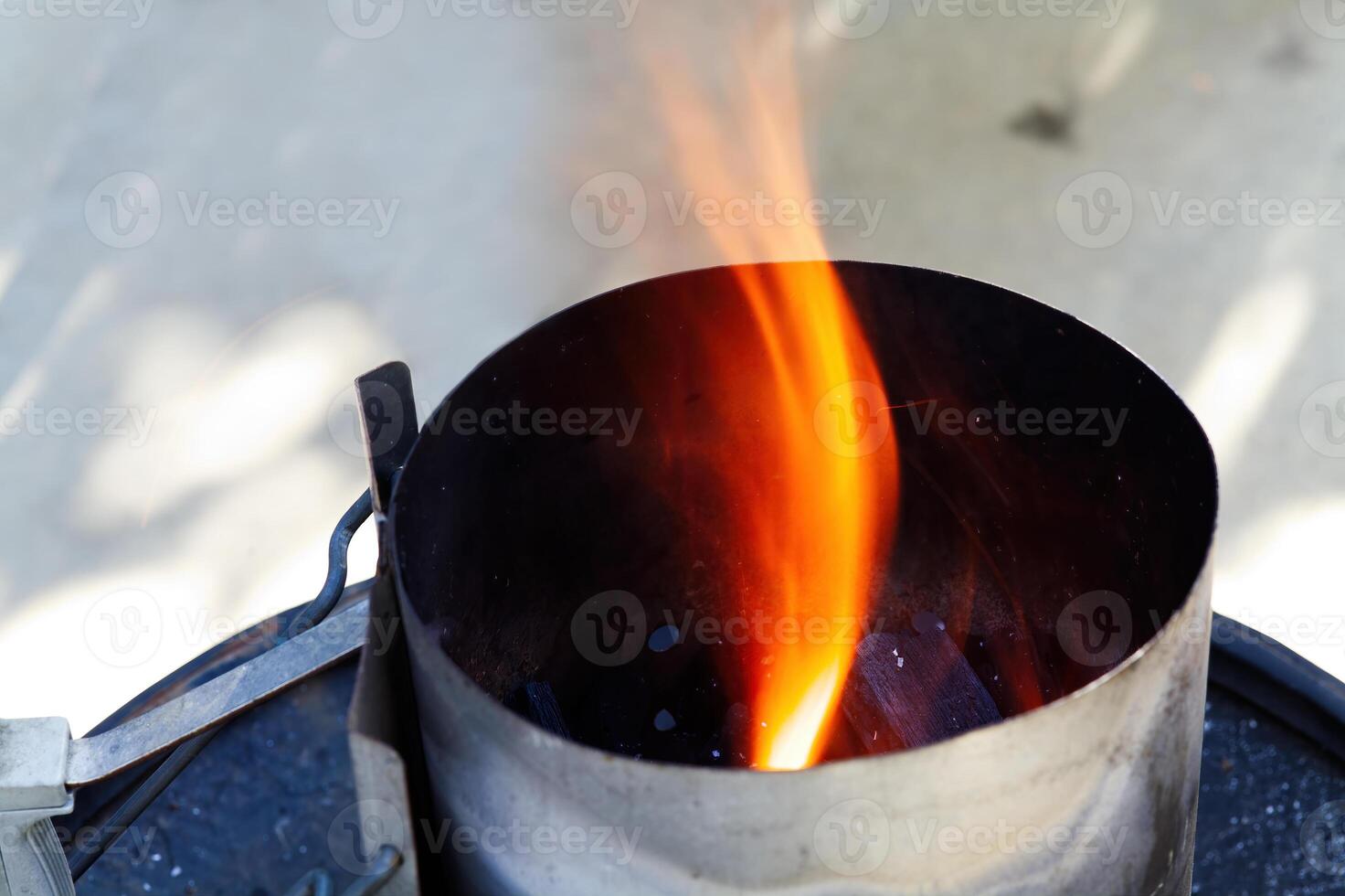 Flames Coming Up Out Of Barbbeque Chimney Starter photo