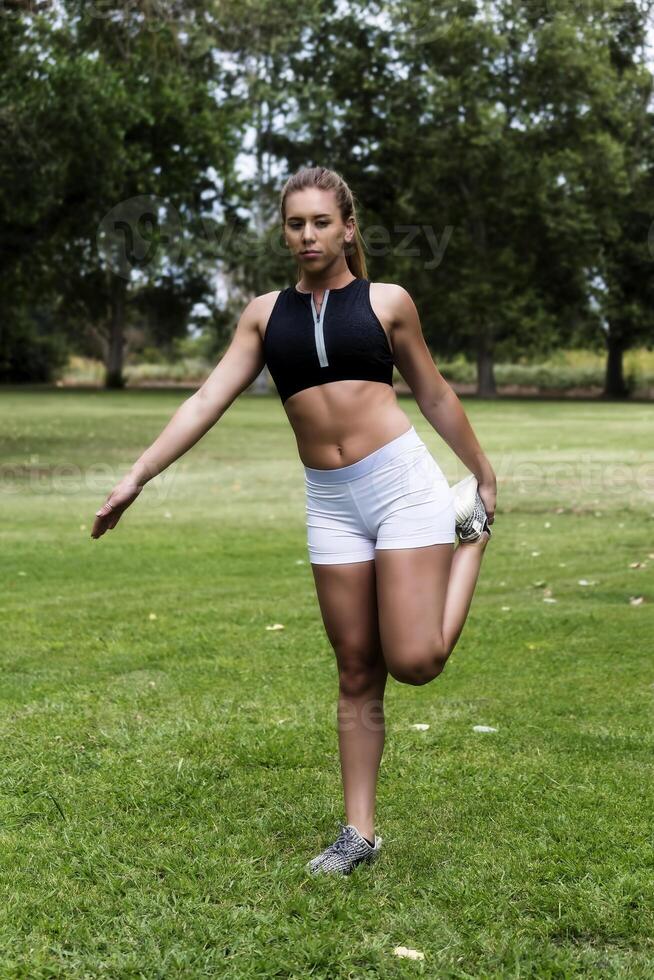 Teen Caucasian Woman Stretching In The Park photo