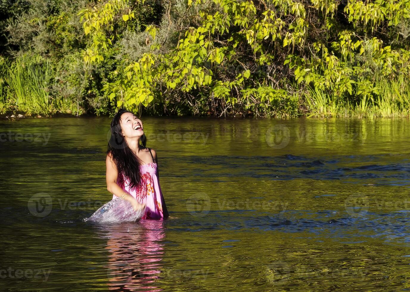 Smiling Japanese American Woman Standing In River photo