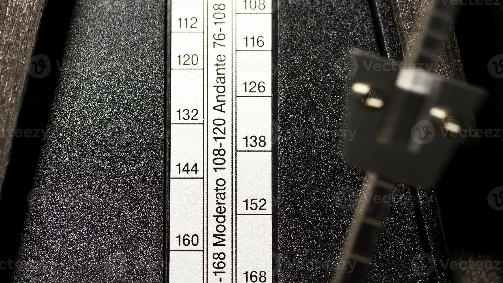Closeup Of Wooden Metronme Showing Tempo Settings photo