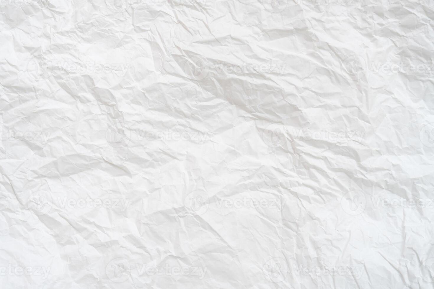 Wrinkled or crumpled white stencil paper or tissue paper after use with large copy space used for background texture photo