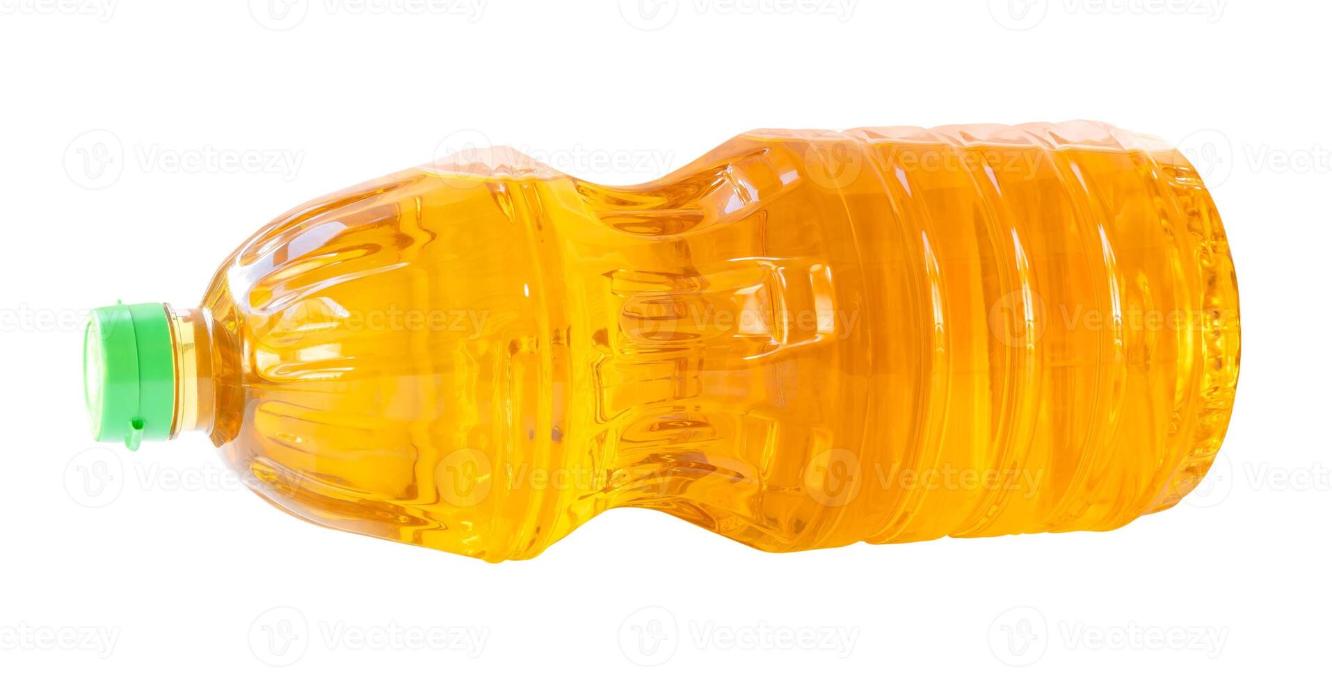 Yellow cooking palm oil or vegetable oil in lying medium transparent plastic bottle isolated on white background with clipping path. photo