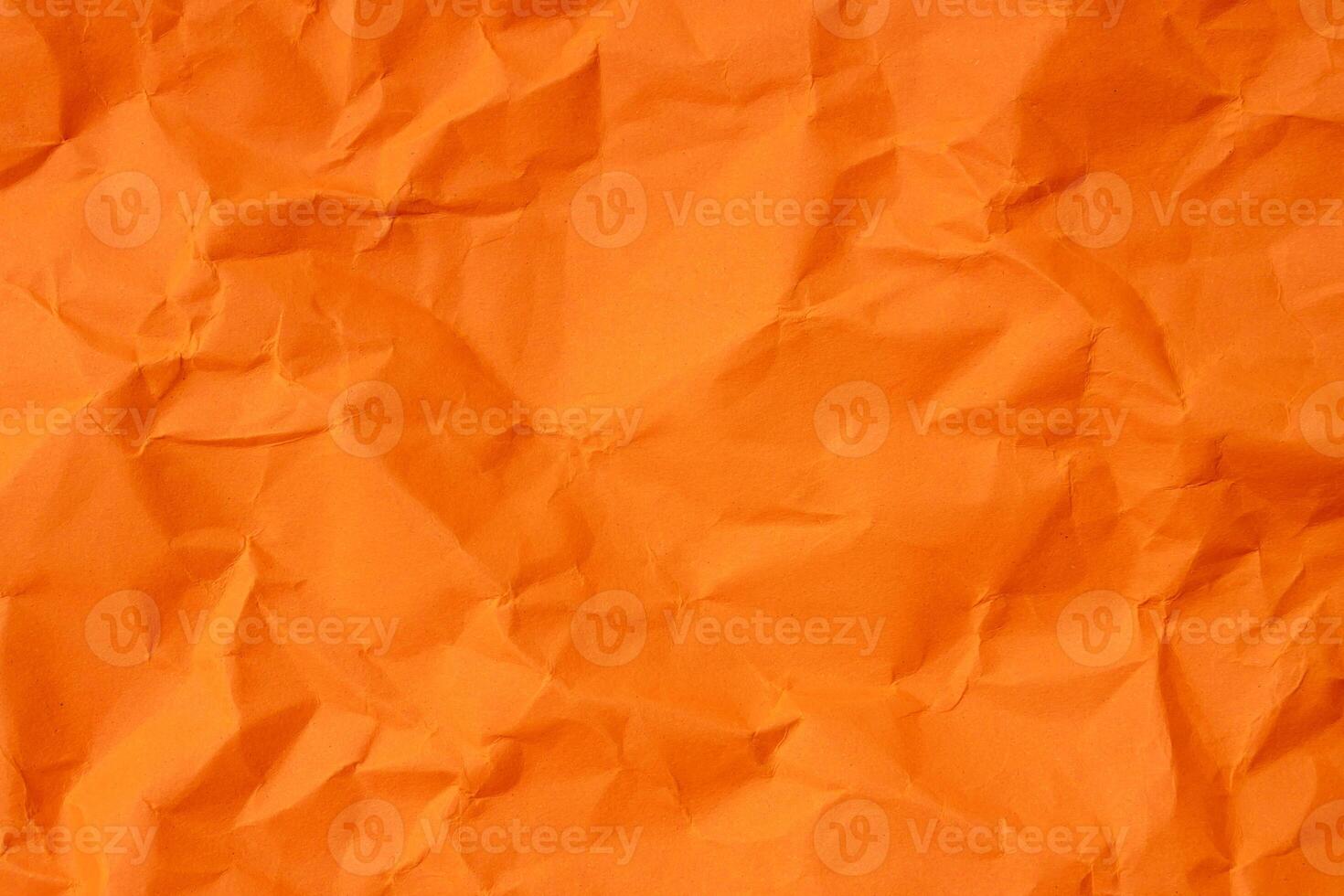 Top view of orange wrinkled or crumpled paper texture used as crumpled paper background texture in decorative art work photo