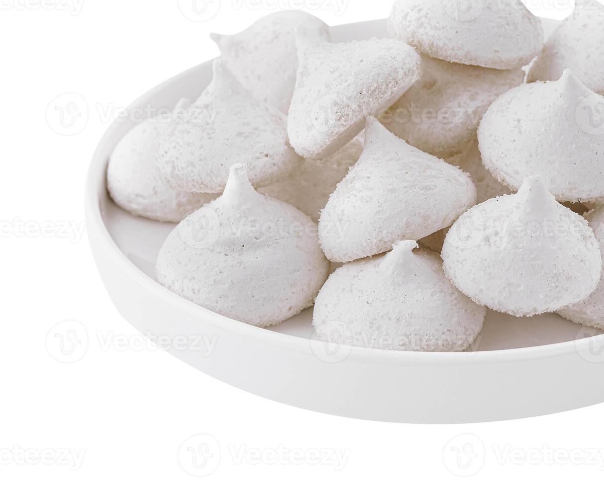 Bowl of meringue cookies isolated on white photo