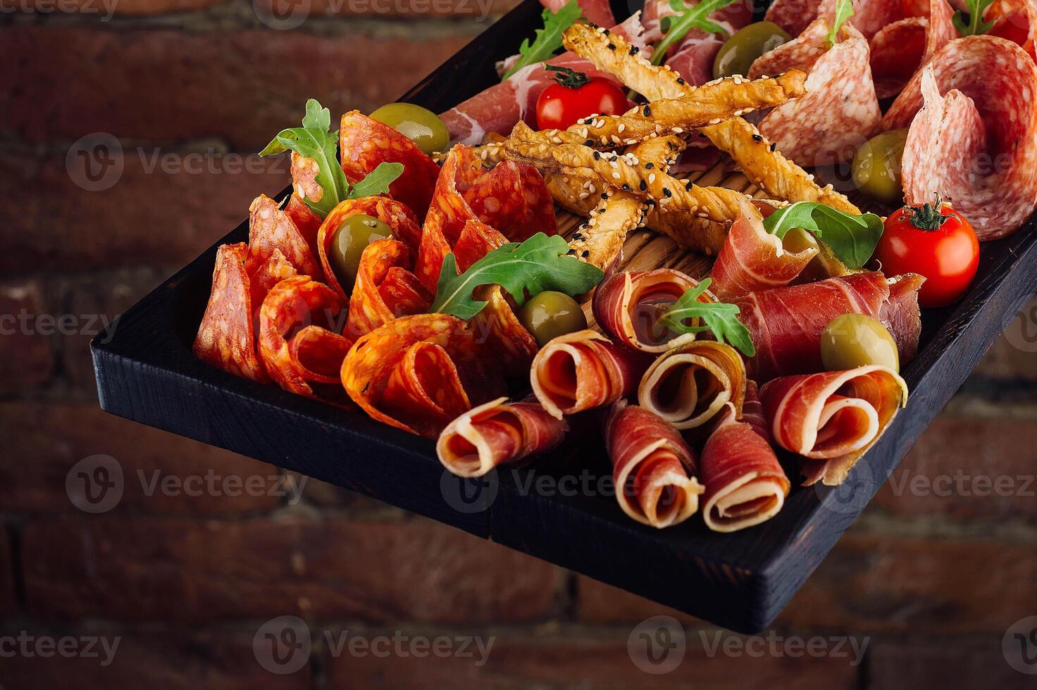 Traditional spanish jamon, prosciutto crudo, italian salami, parma ham photo
