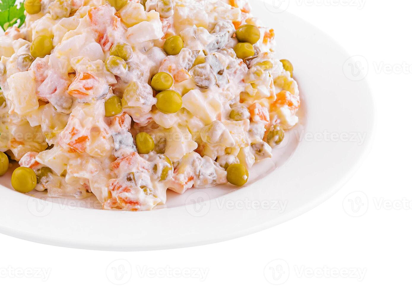 salad Olivier with mayonnaise on plate photo