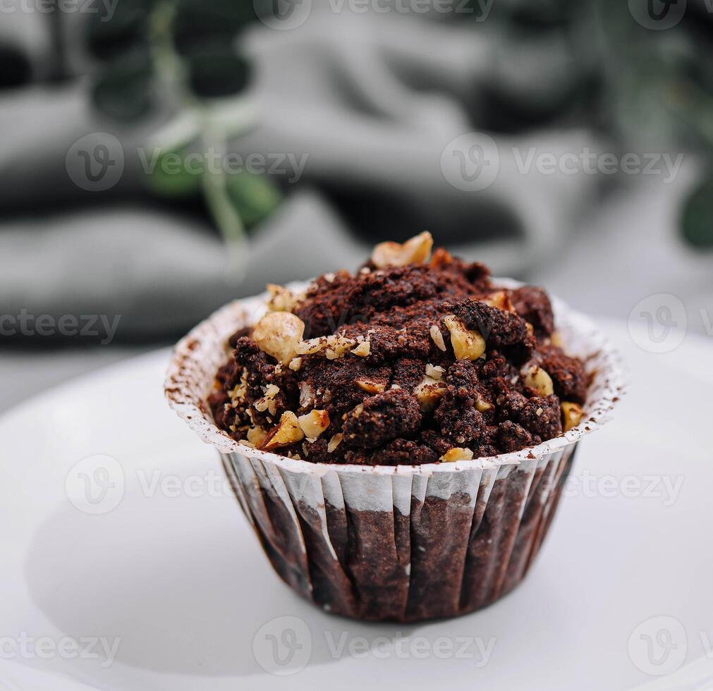 One black chocolate muffins with nuts crumbs photo