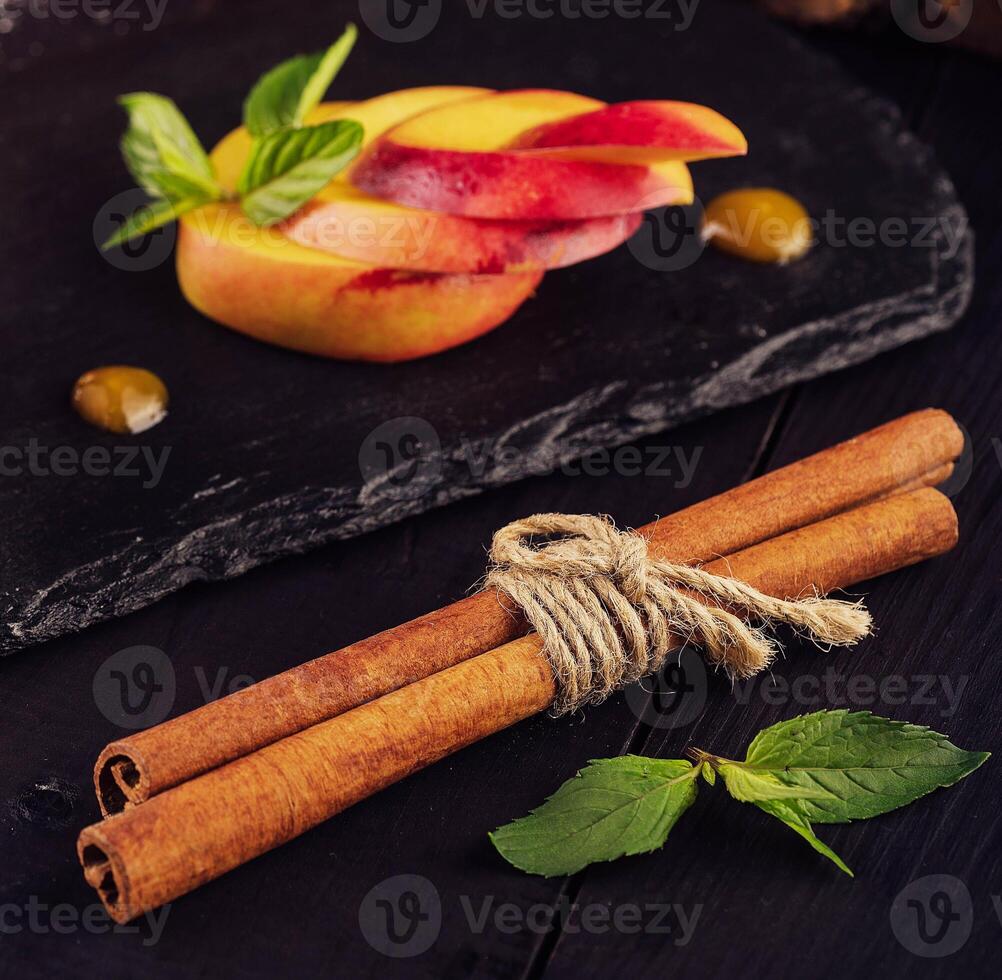 cinnamon sticks with apricot slices close up photo