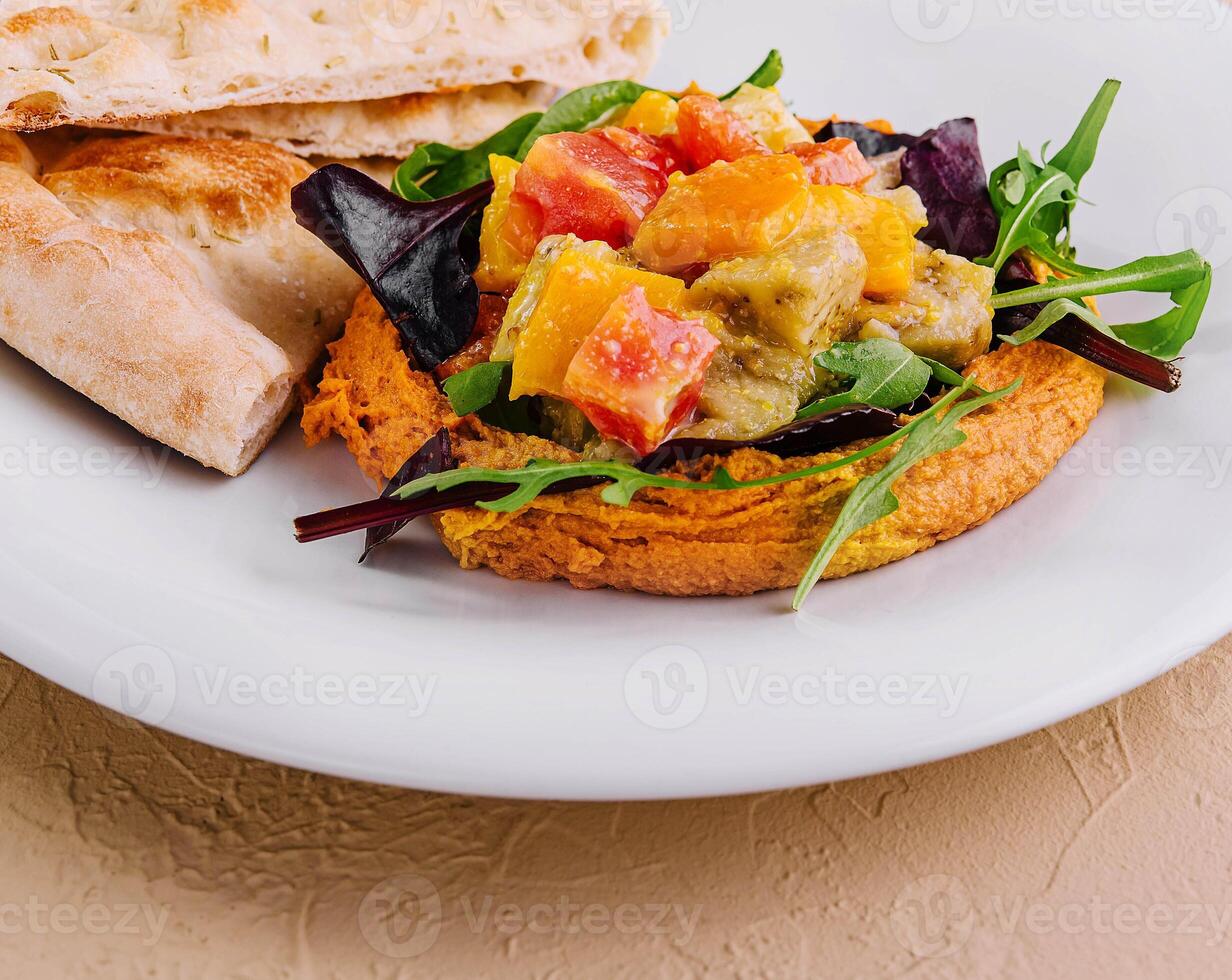 Healthy roasted red pepper hummus and pita bread photo