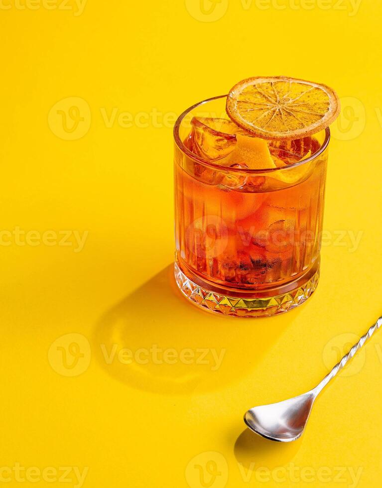 Cocktail Negroni on yellow background photo
