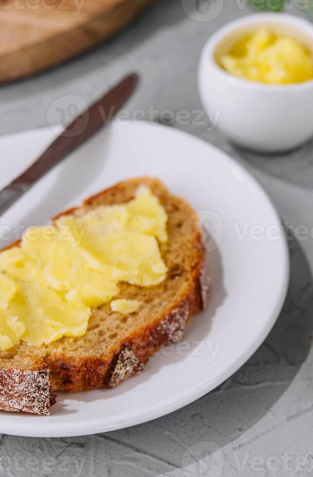 bread and melted butter for breakfast photo