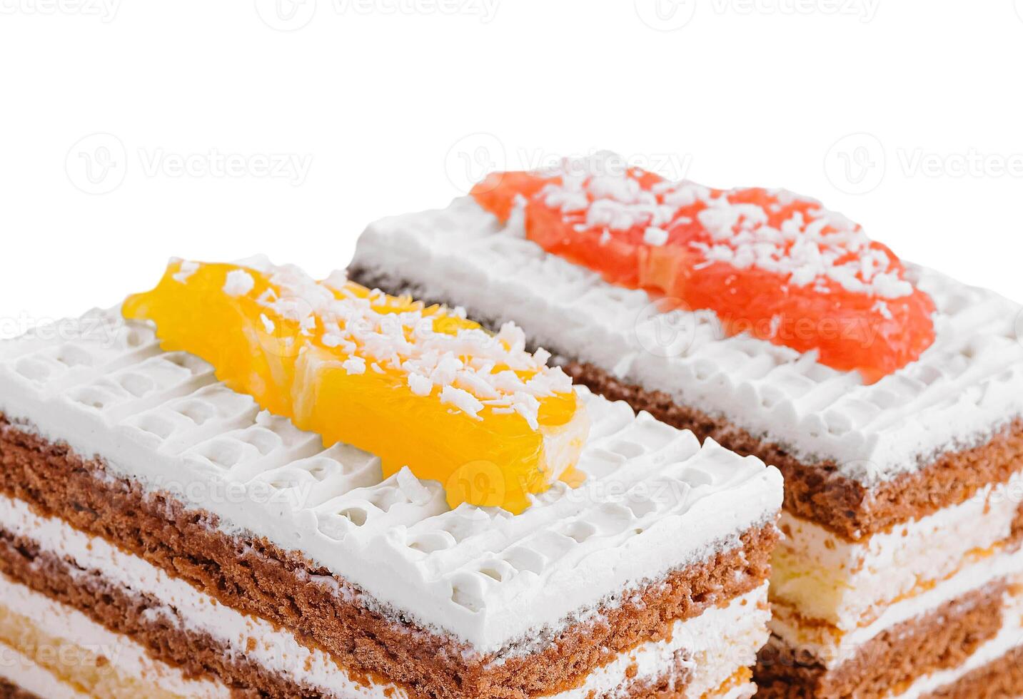two slices of multilayer cocoa sponge cake with coconut flakes photo
