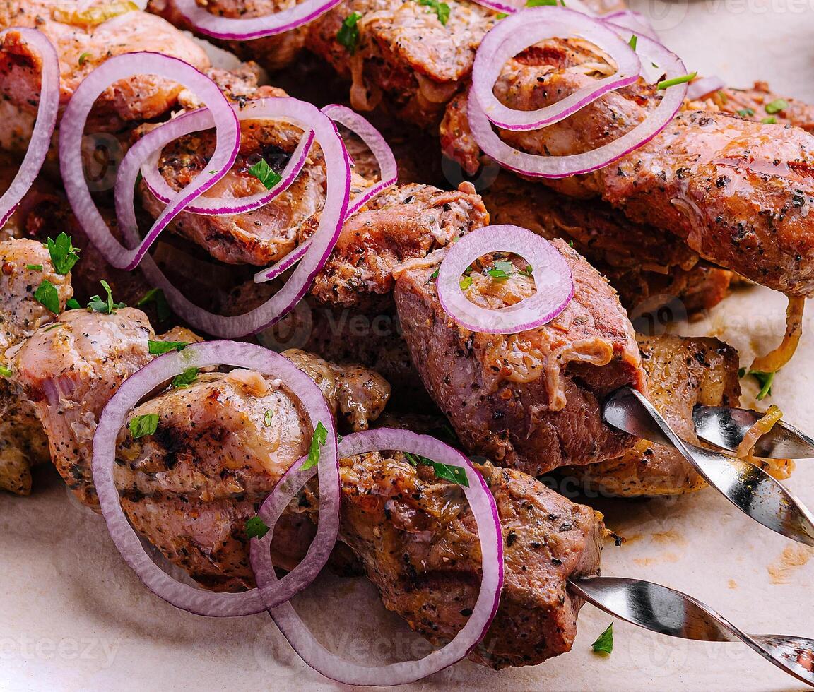 kebabs from pork on skewers on pita bread photo