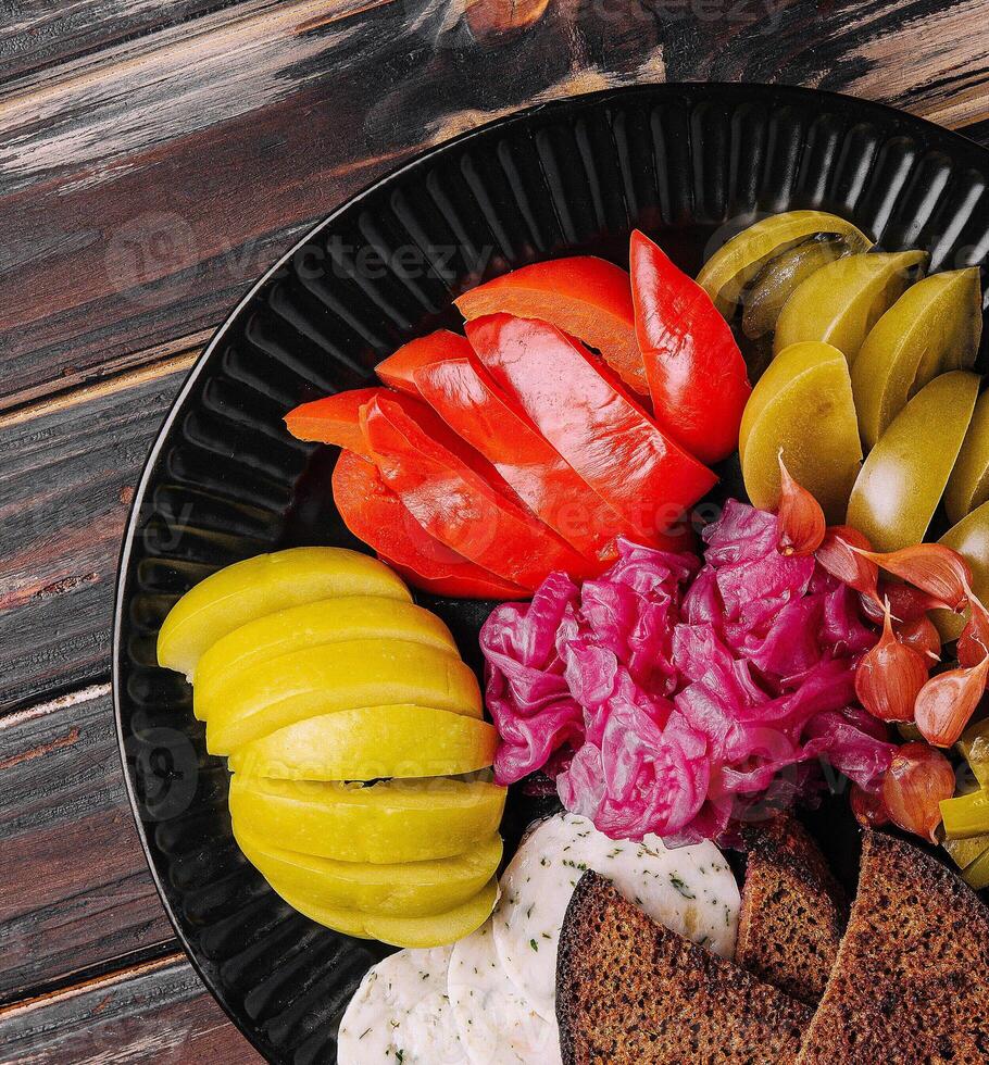 Delicious spicy pickles cut on a serving plate photo