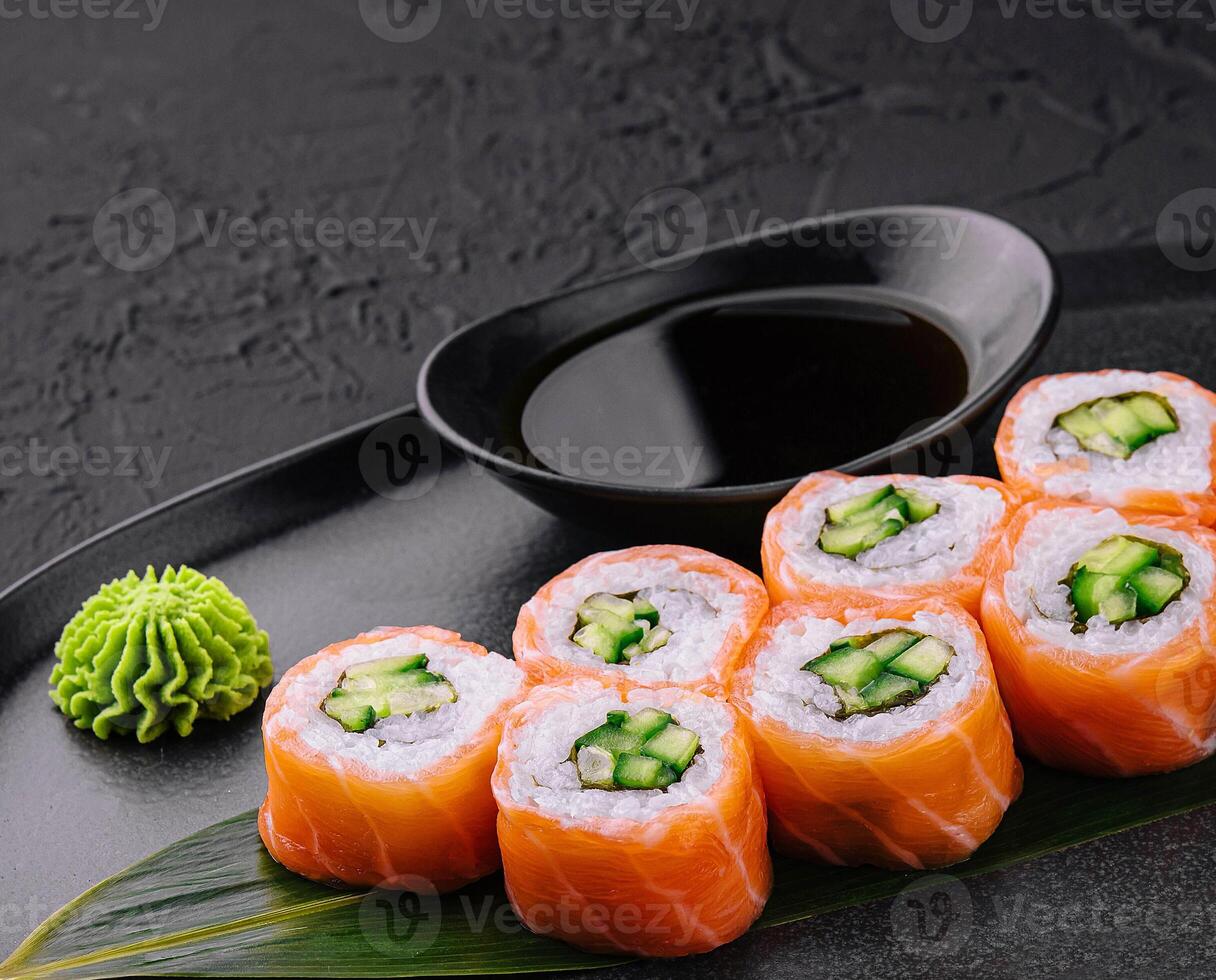 Philadelphia salmon sushi with cucumber inside on plate photo