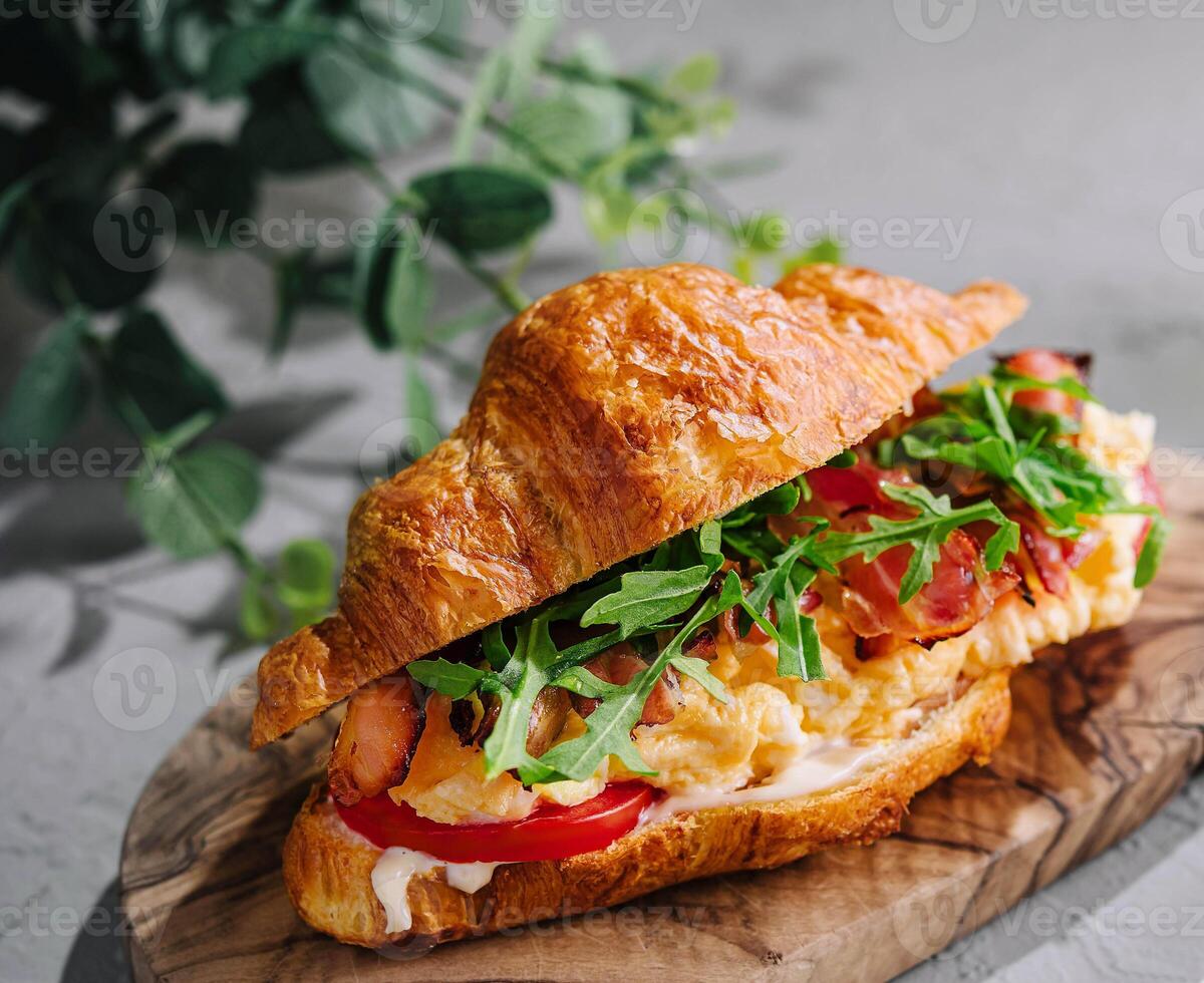 Fresh sandwich with bacon and scrambled eggs photo