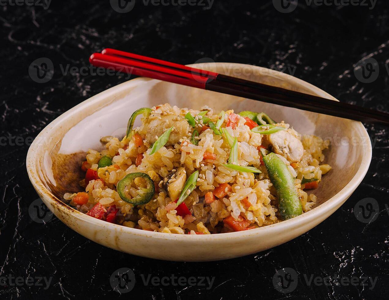 Delicious rice pilaf with vegetables on table photo