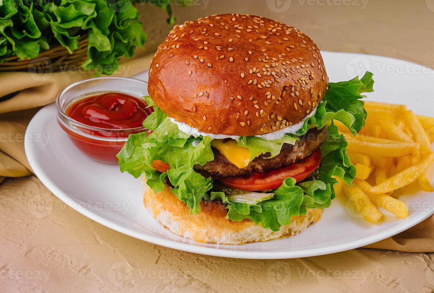 burgers with french fries served on plates photo