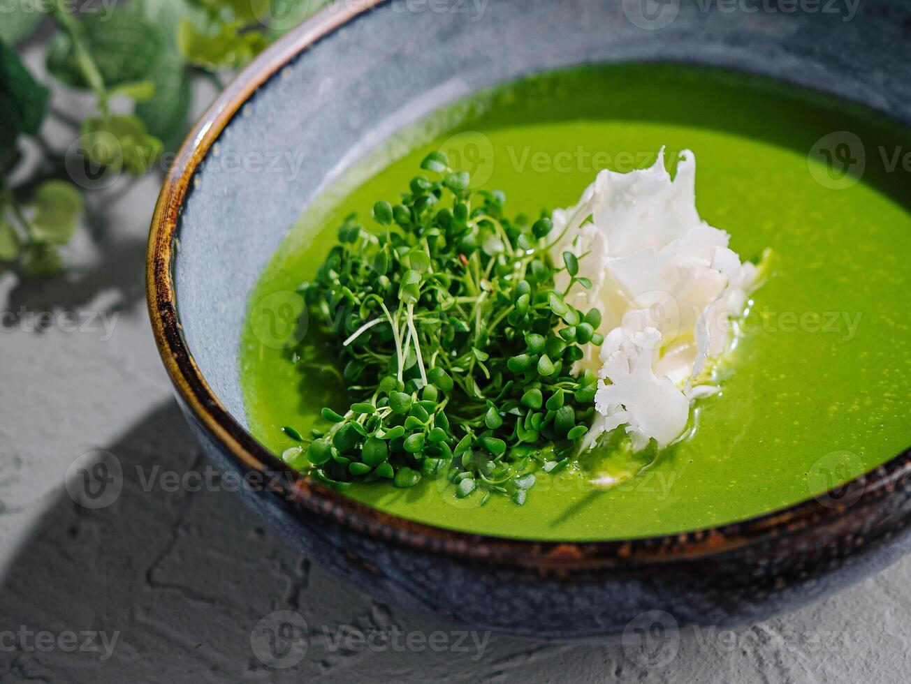 Broccoli, spinach cream soup in a bowl photo