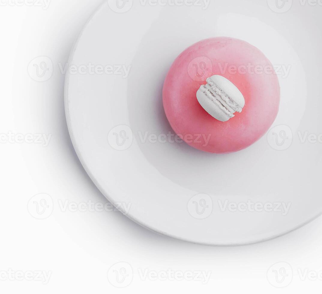 Pink mousse cake decorated with white macaroon photo