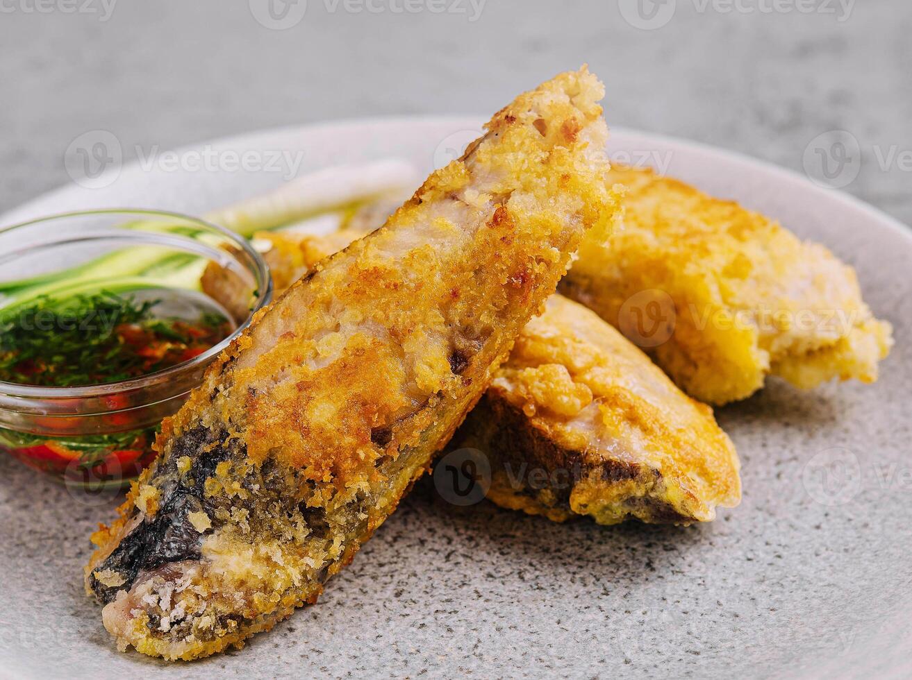close up fried fish fillet with vegetables photo