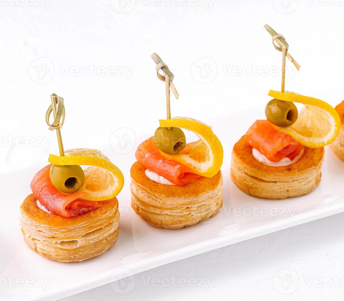 Salmon rolled fillet in pastries isolated on white photo