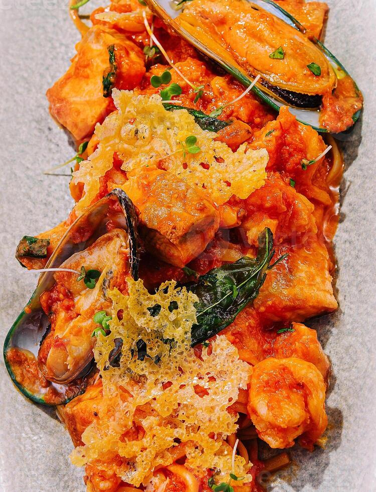 Seafood pasta with shrimps and mussels in tomato sauce photo