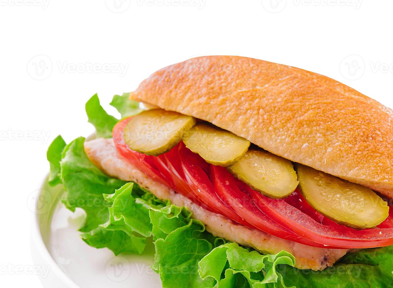 sandwich with cutlet, tomatoes and pickled cucumbers photo