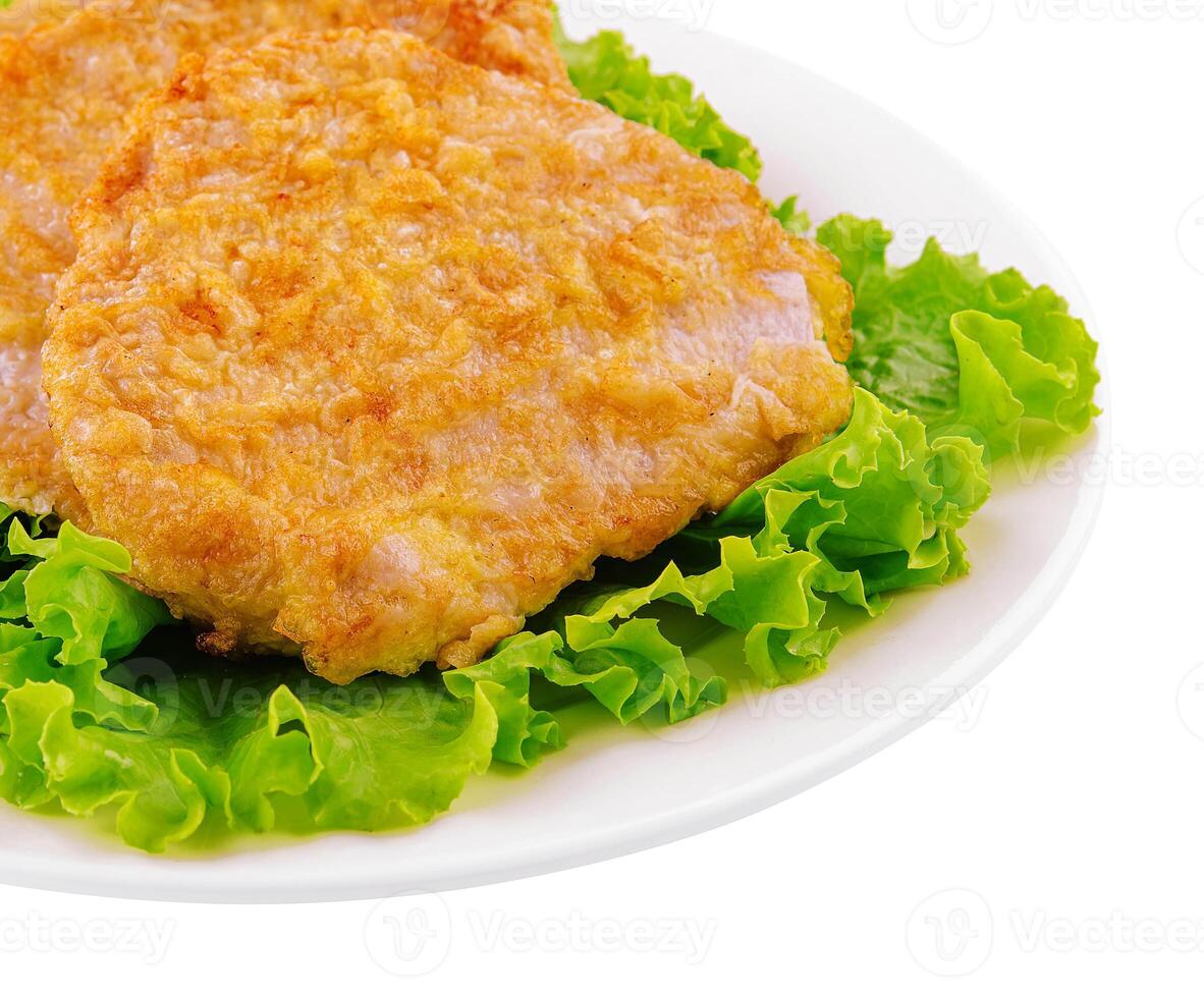 Fried chicken chop on lettuce leaves photo