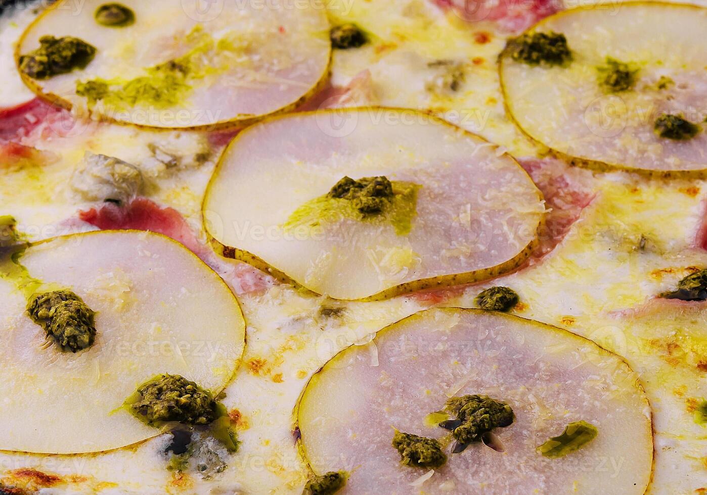 close up pizza with pear, cheese and ham photo