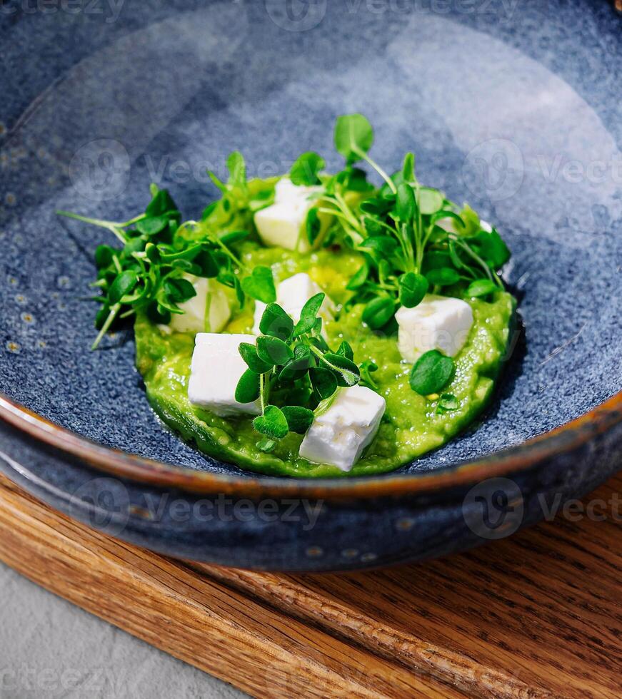 Broccoli, spinach cream soup in a bowl photo