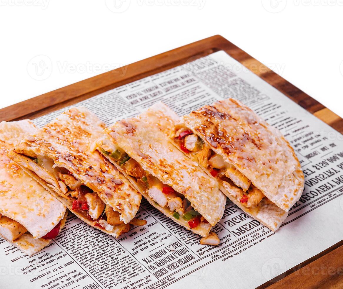 Mexican quesadilla with chicken on wooden board photo