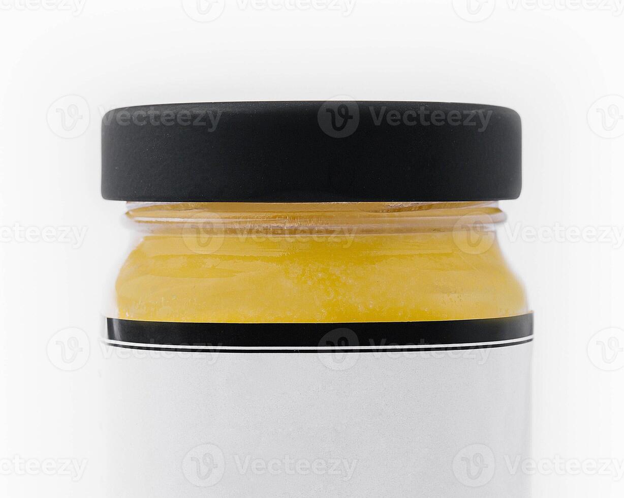 Ghee butter in a glass jar isolated on white photo