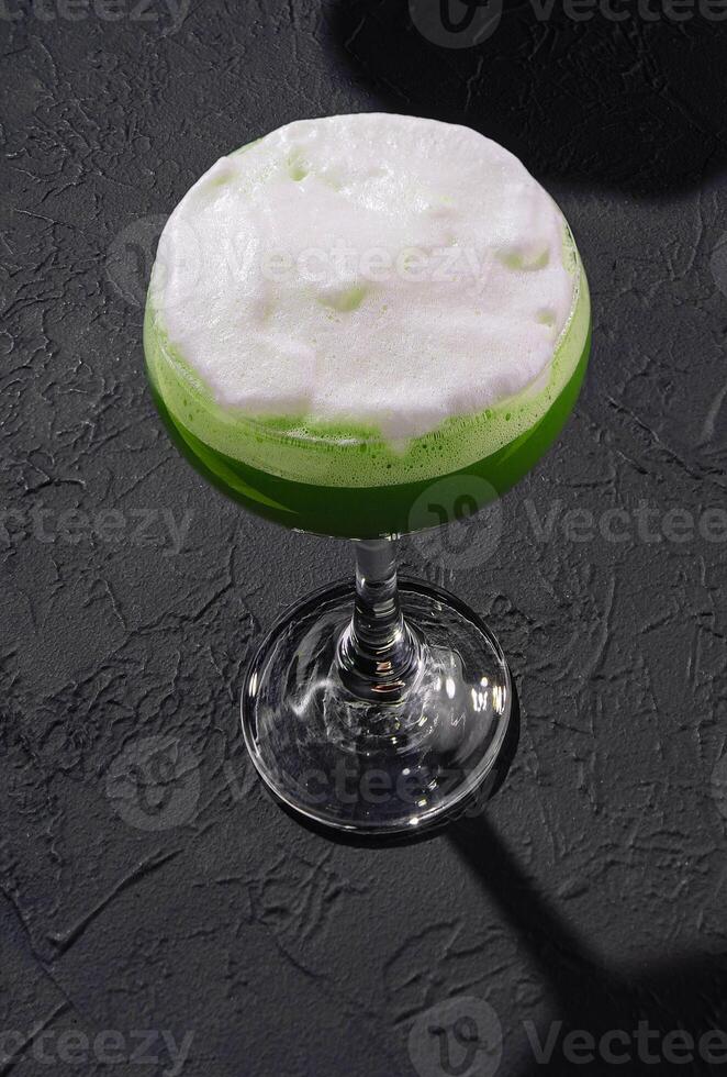 Green alcoholic cocktail for women with foam photo
