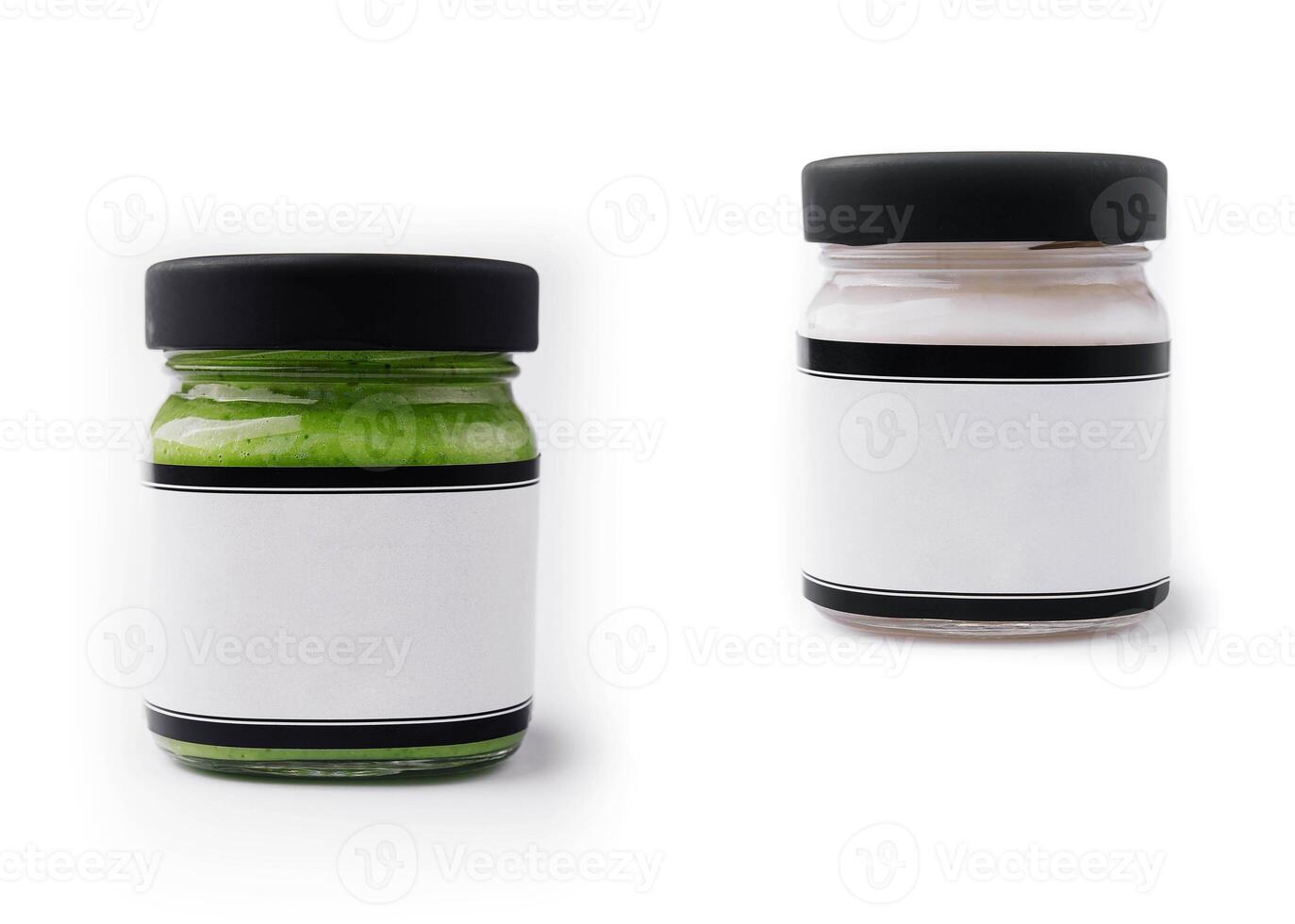 Pesto sauce and cream sauce in a glasses jars isolated photo