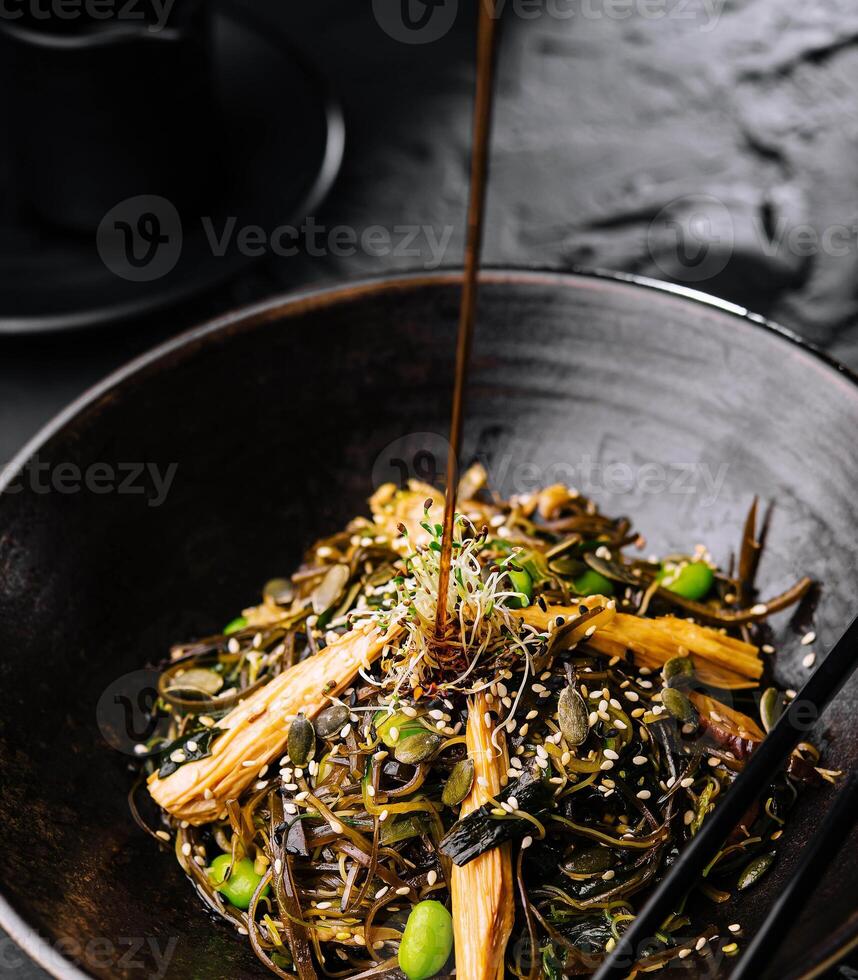 Spicy dish, noodles with meat and vegetables in wok pan photo