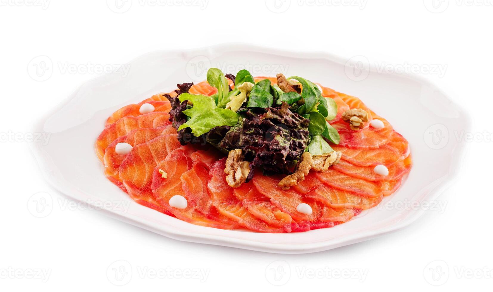 Salmon carpaccio with salad on plate photo