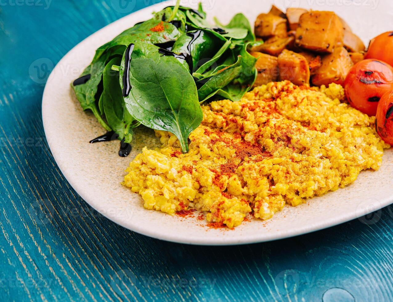 fried scrambled eggs with meat and paprika photo