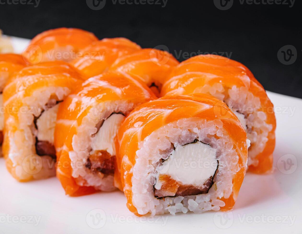 Sushi roll philadelphia with salmon and caviar on plate photo