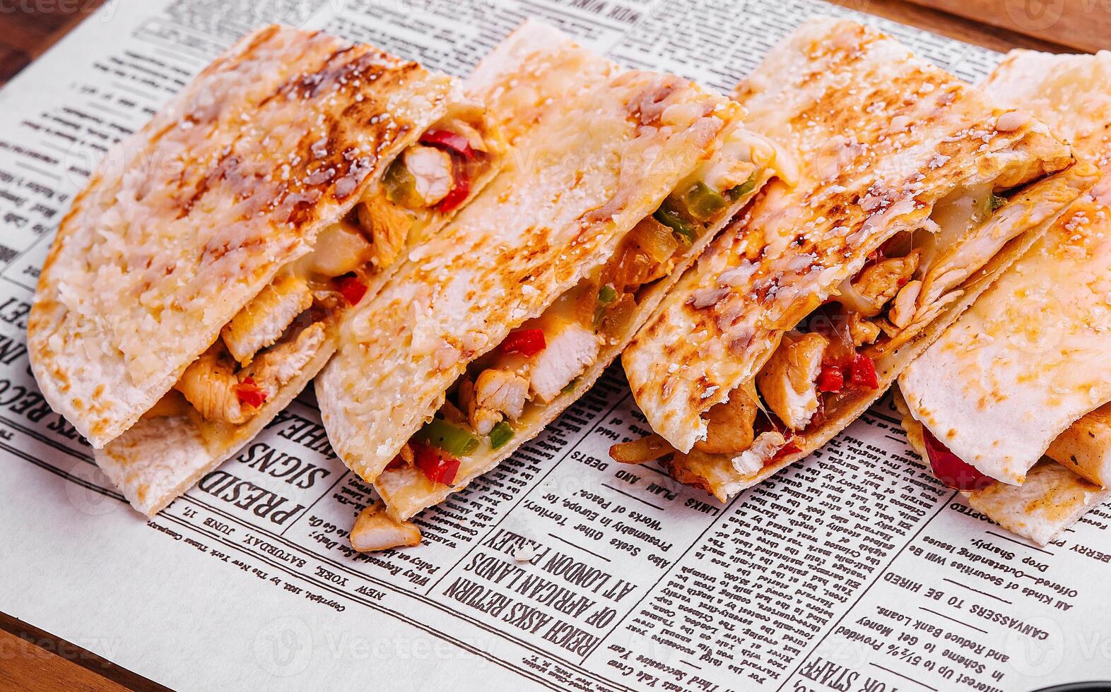 Mexican quesadilla with chicken on wooden board photo