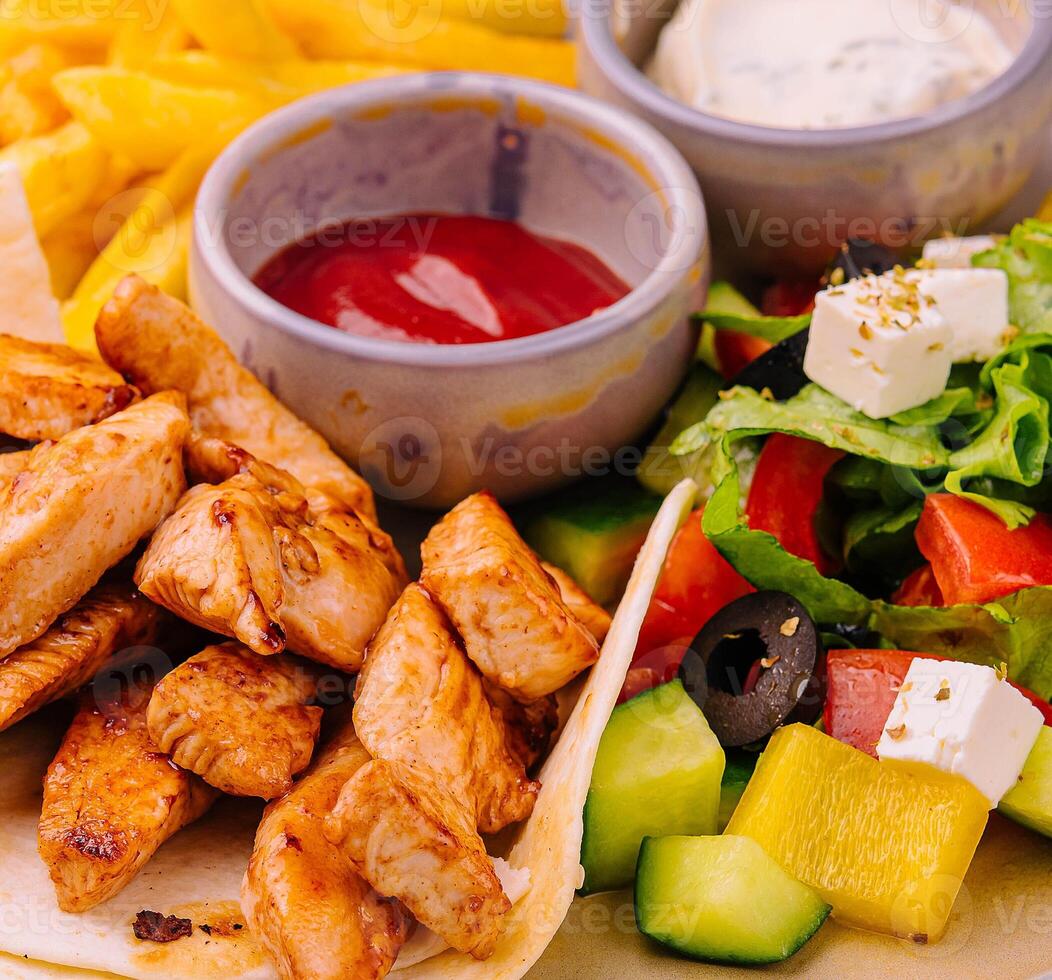 fried chicken breast meat and Greek salad photo