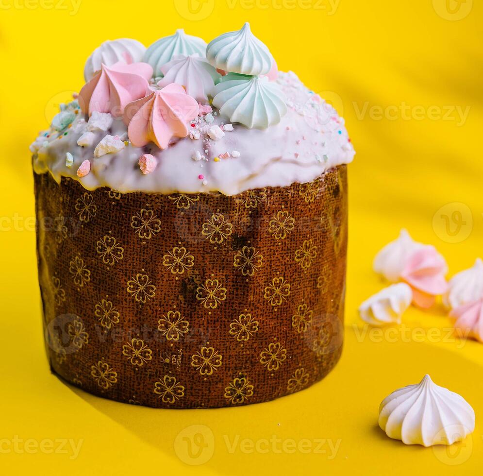 Traditional Easter cakes with meringue on yellow background photo